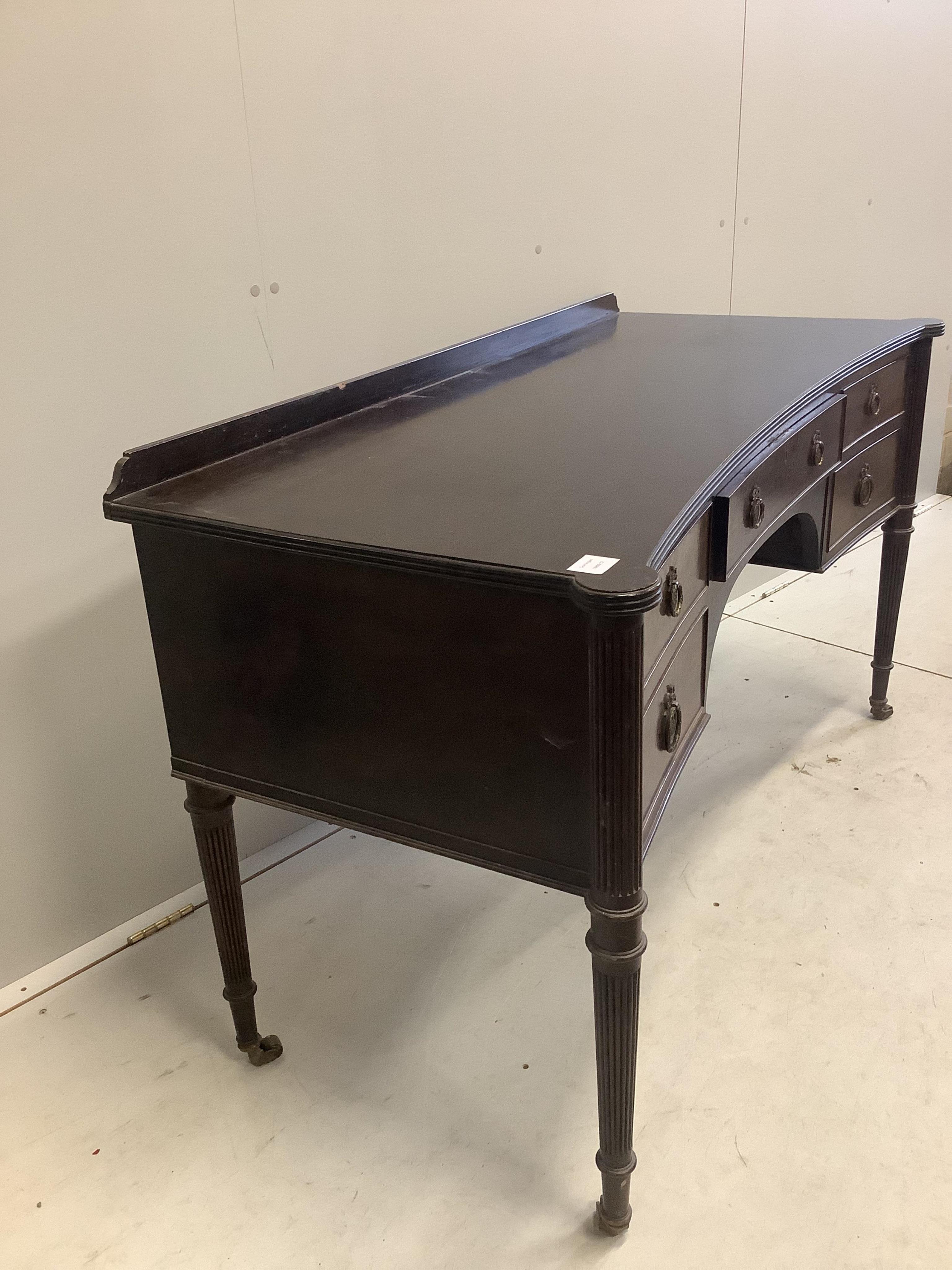 An early 20th century mahogany concave kneehole dressing table, width 136cm, depth 60cm, height 78cm. Condition - fair